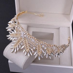 Detailed macro view of gold bridal crown with intricate crystal leaves and floral patterns