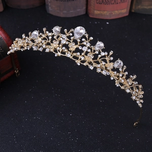Detail of bridal crown with sparkling white rhinestones and gold floral alloy pattern