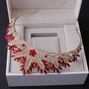 Detail of bridal gold crown featuring red marquise crystals and tiny white rhinestones
