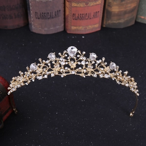 Detailed macro view of gold floral bridal crown featuring intricate rhinestones and crystals