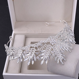 Close-up of silver crystal bridal crown featuring leaf design and shimmering rhinestones