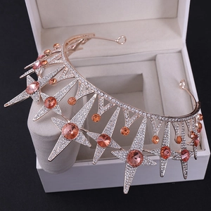 Detail view of rose gold bridal crown with amber rhinestones and starry decorations