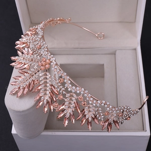 Close-up of rose gold crystal bridal crown with champagne leaf gemstones and diamonds