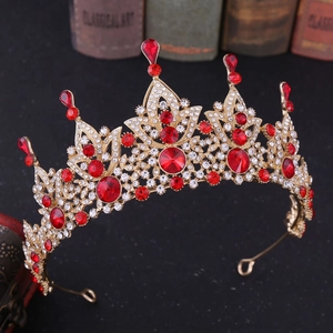Macro shot of luxury baroque crown with red crystals and golden alloy details