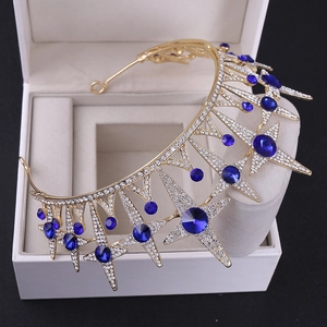 Detail of bridal star crown with gold base, white rhinestones and deep blue crystals