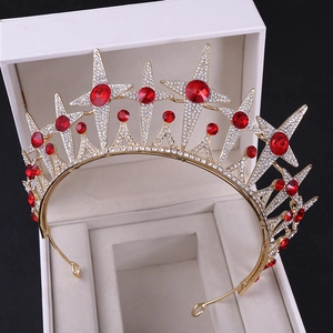 Detailed macro view of a gold star bridal crown with red rubies and white rhinestones