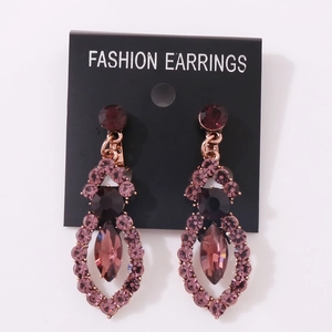 Elegant rose gold drop earrings with purple crystals and marquise stones on white background
