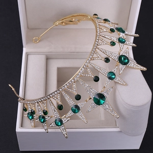 Macro detail of bridal crown featuring gold stars with green gemstones and white crystals