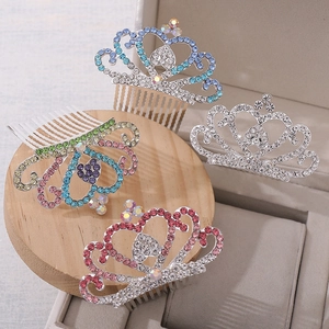 Detail view of colorful crystal rhinestone crowns on silver alloy hair combs for kids