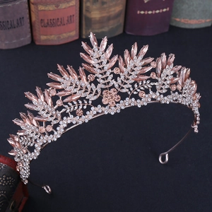 Detailed macro view of champagne crystal tiara with rose gold plating and leaf motifs