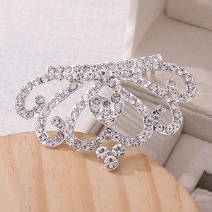 Detailed macro view of heart-shaped crystal crown hair comb with sparkling rhinestones