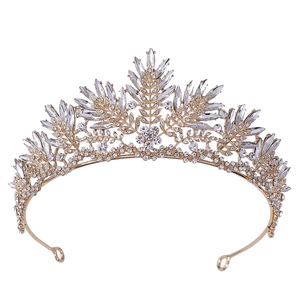 Elegant gold bridal tiara featuring leaf motifs and crystal rhinestones on a white background