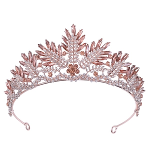 Close-up of rose gold crystal bridal crown with pink rhinestones for weddings