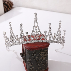 Baroque silver rhinestone bridal crown for weddings on a vintage wooden box background