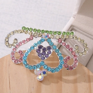 Detail of colorful crystal crown hair comb with heart-shaped purple rhinestone