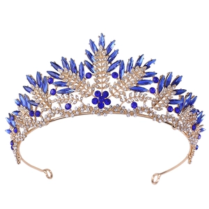 Macro detail of royal gold crown with deep blue crystals and sparkling rhinestones