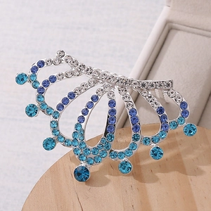 Close-up of sparkling blue rhinestones on a silver crown hair comb for girls