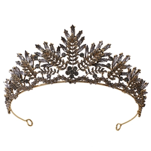 Detailed macro view of vintage bronze crystal crown with baroque leaf motifs and grey rhinestones