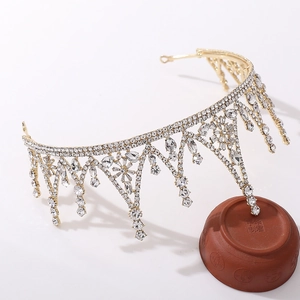 Detail view of golden baroque crown with sparkling crystals and teardrop pendants