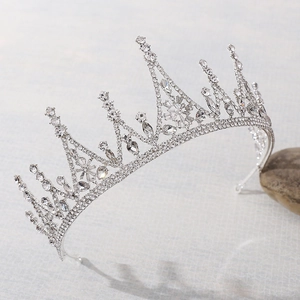 Macro view of bridal crown detailing silver-tone alloy base with clear crystal flower