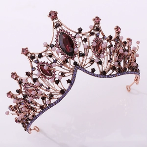 Close-up of Baroque vintage black crown with purple gemstones and pink pearls