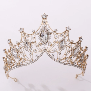 Detail of golden Baroque bridal crown with intricate crystal embellishments and marquise gems