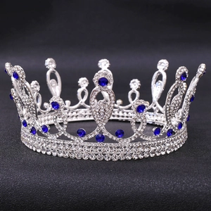Detailed close-up of a silver bridal crown featuring brilliant blue rhinestones and gems