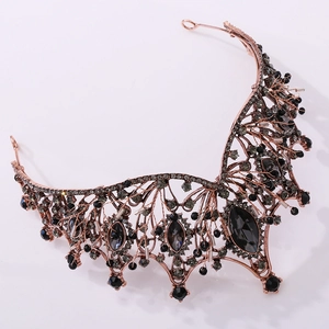 Close-up of vintage baroque bridal crown with dark grey gems and rose gold alloy frame