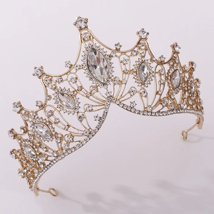 Macro detail of a golden baroque crown featuring sparkling crystals for wedding bridal wear