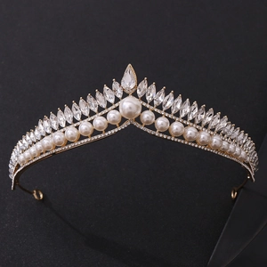 Close-up of golden bridal crown with white pearls and sparkling marquise-cut rhinestones