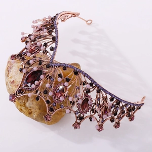 Close-up of rose gold baroque crown with purple marquise stones and pink bead details