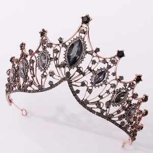 Macro detail of rose gold baroque crown featuring black crystals and intricate镂空patterns