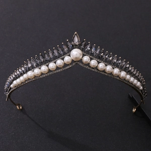 Detailed close-up of a silver tiara with white pearls and marquise cut gray crystals