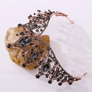 Detailed macro view of Gothic baroque bridal crown with black rhinestones and rose gold frame