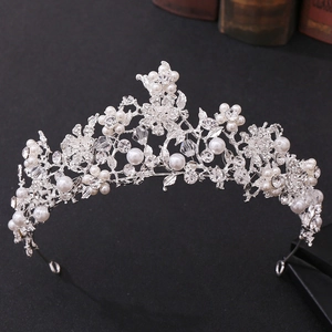 Close-up of floral bridal crown with sparkling crystals and handmade white pearls