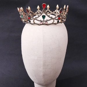 Detailed macro view of an antique gold baroque crown with multi-colored crystals