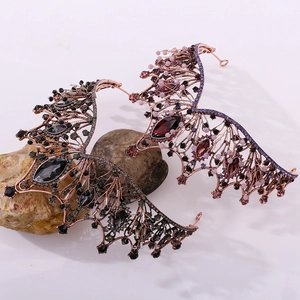 Detail of baroque black and purple wing tiaras with vintage rose gold metal finish