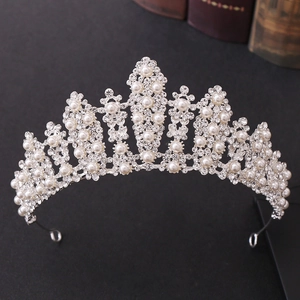 Dettaglio della tiara da sposa vintage con strass scintillanti e perle bianche su sfondo nero