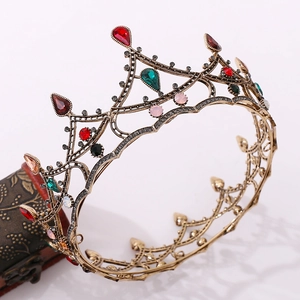 Macro detail of luxury baroque crown with red and green crystals on bronze lace structure