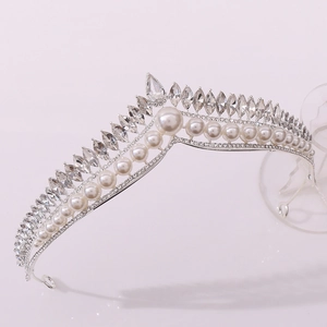 Close-up of elegant bridal crown with white pearls and sparkling marquise rhinestones