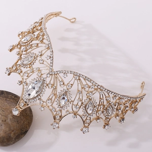 Close-up of golden butterfly bridal crown with sparkling crystal rhinestones and metal details