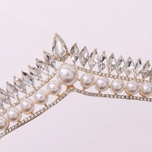 Detailed close-up of bridal crown featuring pearls and marquise crystals on gold base
