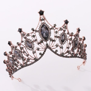 Macro view of vintage rose gold crown with intricate black crystals and hollow patterns