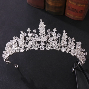 Close-up of handmade bridal crown featuring red crystals and intricate beadwork details