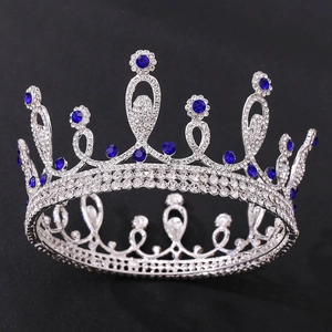 Elegant silver bridal crown with white rhinestones and blue crystals on black background