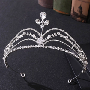 Close-up of silver bridal tiara featuring drop-shaped rhinestones and floral vine patterns