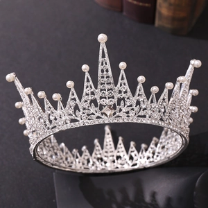 Detailed close-up of a silver tiara featuring sparkling rhinestones and white pearls