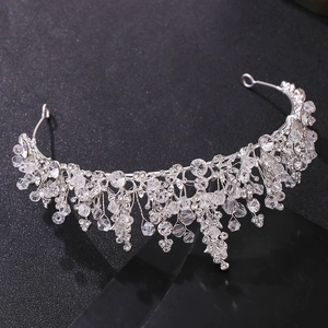 Detailed view of silver bridal crown featuring red beads and shimmering crystal fringes