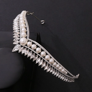 Detailed view of silver bridal crown featuring marquise crystals and round white pearls