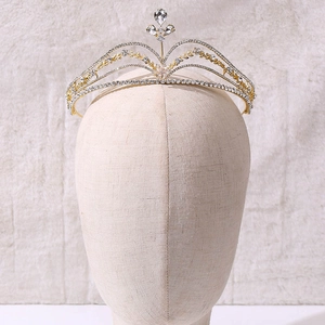Close-up of golden bridal tiara with sparkling rhinestones and floral drop gems